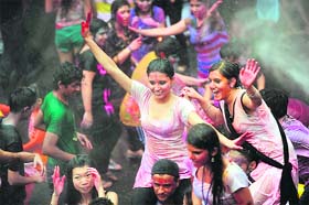 Colour riot: Revellers covered in coloured powders celebrate Holi in Hong Kong on Sunday