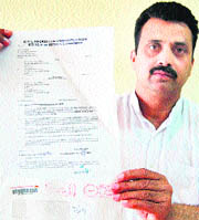RTI activist Ravinder Sultanwind shows documents in Amritsar on Monday. 
