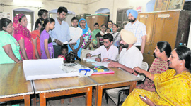 Girl students accompanied by their parents seek admission to the Government Senior Secondary School on the Mall Road in Bathinda on Monday.