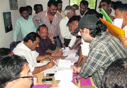 Congress candidates submit their applications for nominations for municipal councillors to senior party leader Tilak Raj Behad at Congress Bhavan in Dehradun on Monday.