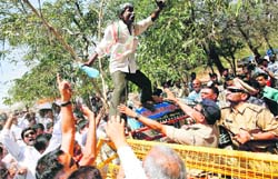 A Congress activist shouts as he stands on a police barricade during a protest at Gandhinagar on Monday. Farmers and Congress activists are demanding 12-hour electricity supply for farmers and a roll-back of the Gujarat Irrigation and Drainage Bill that was passed recently.  Reuters