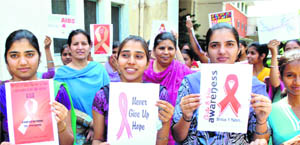Members of the GCG Red Ribbon Club hold an awareness rally on AIDS in Patiala on Monday. 