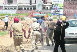 Policemen chase protesters at Kharar on Tuesday. A Tribune photograph
