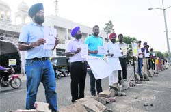 Residents protest in front of the Phase V gurdwara in Mohali on Tuesday. Tribune photo: Vicky Gharu