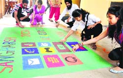 Students of the department of computer science and applications, Panjab University, take part in a rangoli-making competition on Tuesday. Tribune photo: Pradeep Tewari
