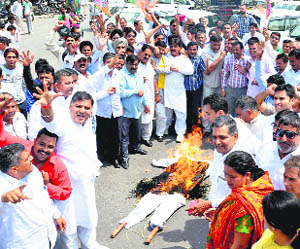 Activists of the BJP and HJC burn an effigy of the Chief Minister against the increase in power rates in Karnal on Tuesday. 