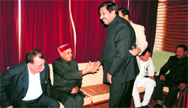 Industries Minister Mukesh Agnihotri persuades Leader of Opposition PK Dhumal to attend the Assembly session in Shimla on Tuesday.