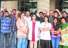 Paramedical staff of PIMS protest against the non-payment of salaries by the management in Jalandhar on Tuesday