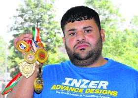 National-level powerlifter Ajay Gogna shows his medals in Jalandhar