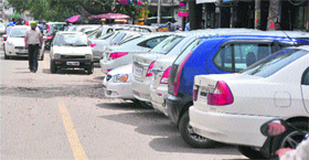 Vehicles being parked alongside the road surrounding Feroze Gandhi Market in Ludhiana on Tuesday.