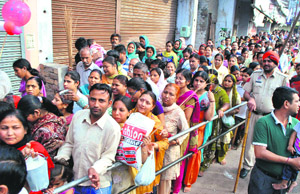 Devotees queue up to visit the historical Mata Shitala Temple in Patiala on Tuesday.