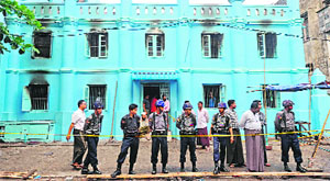 Policemen stand outside an Islamic school after a fire broke out at the school in Yangon, Myanmar, on Tuesday. Thirteen persons, including children, were killed in the fire that broke out due to a suspected electrical fault