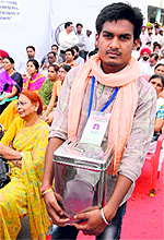 a man holding a donation box during the Jantantra Yatra rally, in Bathinda on Wednesday
