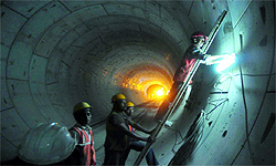 Workers at the underground construction site of the third phase of tunnelling work for the Janpath Metro station in New Delhi on Wednesday
