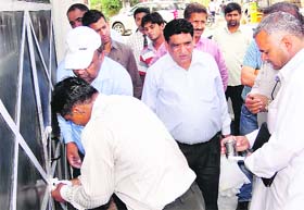 A HUDA team seals a shop running illegally in a Karnal sector on Wednesday