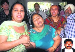 Relatives console Meena (centre), wife of Mukesh Kumar (inset), who died due to alleged negligence of doctors at BBC Heart Care Pruthi Hospital. Tribune photo: Malkiat Singh