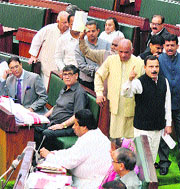 Opposition members stage a walkout after creating an uproar in the Assembly on Wednesday over the rehabilitation policy of militants. 