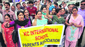 Members of KC International School Parents Association protest in Jammu on Wednesday.