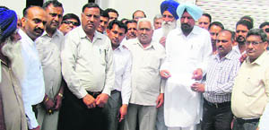 MLA Iqbal Singh Jhoondan presents cheques to office-bearers of social organisations in Mandi Ahmedgarh on Wednesday. 