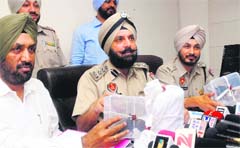 Yurinder Singh Hayre (centre), SSP- Rural, shows the weapons recovered from those involved in Assistant Sub-Inspector Gurdev Singhs murder at a press meet in Jalandhar on Wednesday. Tribune photo: Malkiat Singh