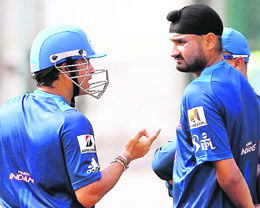 Mumbai Indians teammates Sachin Tendulkar and Harbhajan Singh share a point on Wednesday.