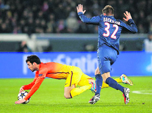Barcelonas Cesc Fabregas crashes to the ground as David Beckham of Paris Saint Germain gestures to indicate his innocence during their Champions League quarterfinal first leg match in Paris on Tuesday. 