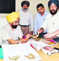 Team of the mobile wing of the State Excise Department with the two kg gold seized from the Amritsar-Jaipur Express in Amritsar on Thursday. Photo: Vishal Kumar