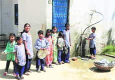 Students of Government Primary School wash utensils after taking their mid-day meal while Chief Minister Parkash Singh Badal was holding Sangat Darshan on the school premises at Korewala Kalan village in Moga district on Thursday.
