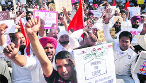 Members of the Philips Workers Association protest outside Bawa White House at Phase IX in Mohali on Thursday.