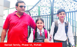 Sameer Bansal comes out of a school with his children at Phase VI in Mohali. 
