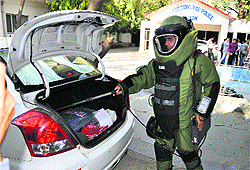 A police official demonstrates equipment of the bomb disposal squad in Gurgaon to deal with terror or distractive activities