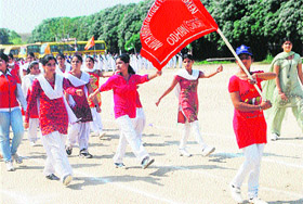 Girls perform a march past during the annual athletics meet of Mata Harki Devi College for Women at Odhan in Sirsa. 