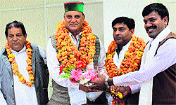 Jagdish Sapiya, Chairman, KCC Bank, with DC C Palrasu in Dharamsala on Thursday