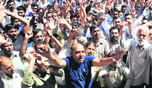 Members of the PHE Workers Welfare Association stage a protest in Jammu on Thursday. 