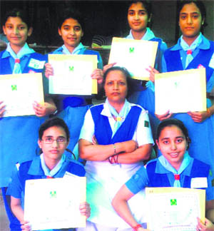 Students of Oriental Academy pose for a photograph after being presented Governors Award for excellence in scout and guide activities in Jammu. 