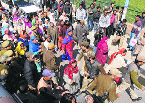 Residents of SDA Colony Noorbagh, at the Lal Chowk Road in Srinagar on Thursday. 