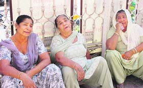 The patients relatives grieve outside the hospital in Ludhiana