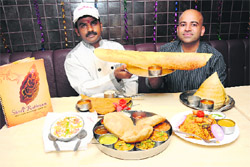 Chef Shekhar and restaurateur Manish Goyal (L) pose with the delicacies 