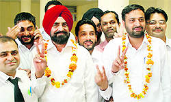 Mahinder Singh Sidhu and Bikramjit Singh Ahluwalia flash the victory sign after being elected the president and secretary of the District Bar Association on Friday