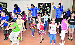 Children and teachers of RIMT World School, present a dance item on the school premises in Mani Majra
