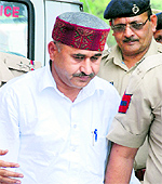 Doon MLA RK Chaudhary being produced in a court in Panchkula