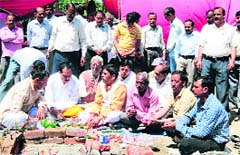 Class IV employees hold a yajna in support of their demands in Dehradun on Friday. 