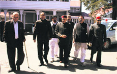 Opposition PK Dhumal and other Bharatiya Janata Party legislators go to the Assembly in Shimla on Friday.