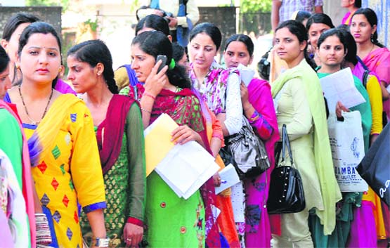 Long wait : Heavy rush of BEd students at the University of Jammu for submitting examination forms on Thursday. Tribune Photo: Inderjeet Singh