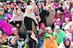 PDP president Mehbooba Mufti along with relatives of Kokernag bus accident victims at Mohiripora village in Anantnag on Friday. Tribune photo: Amin war
