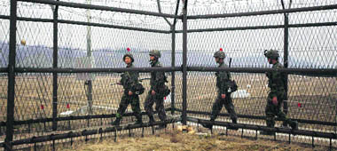 South Korean soldiers patrol along a barbed-wire fence, near the demilitarized zone that separates the two Koreas in Paju, north of Seoul, on Friday.