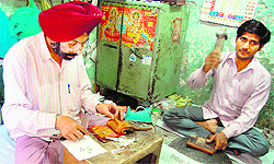 Jaspal Singh prepares silver leaves in Amritsar