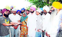 A devotee demands action against the accused from SGPC member Amrik Singh Nambardar (extreme right) at Kot Shamir village of Bathinda district on Saturday