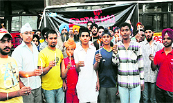 Residents hold a candle light vigil to protest against the decision of the state government to ban the screening of Punjabi movie Sadda Haq, in Bathinda on Saturday
