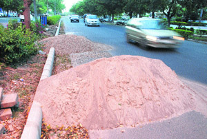 Heaps of sand and gravel lie in the middle of a road dividing Sectors 10 and 11 in Panchkula.